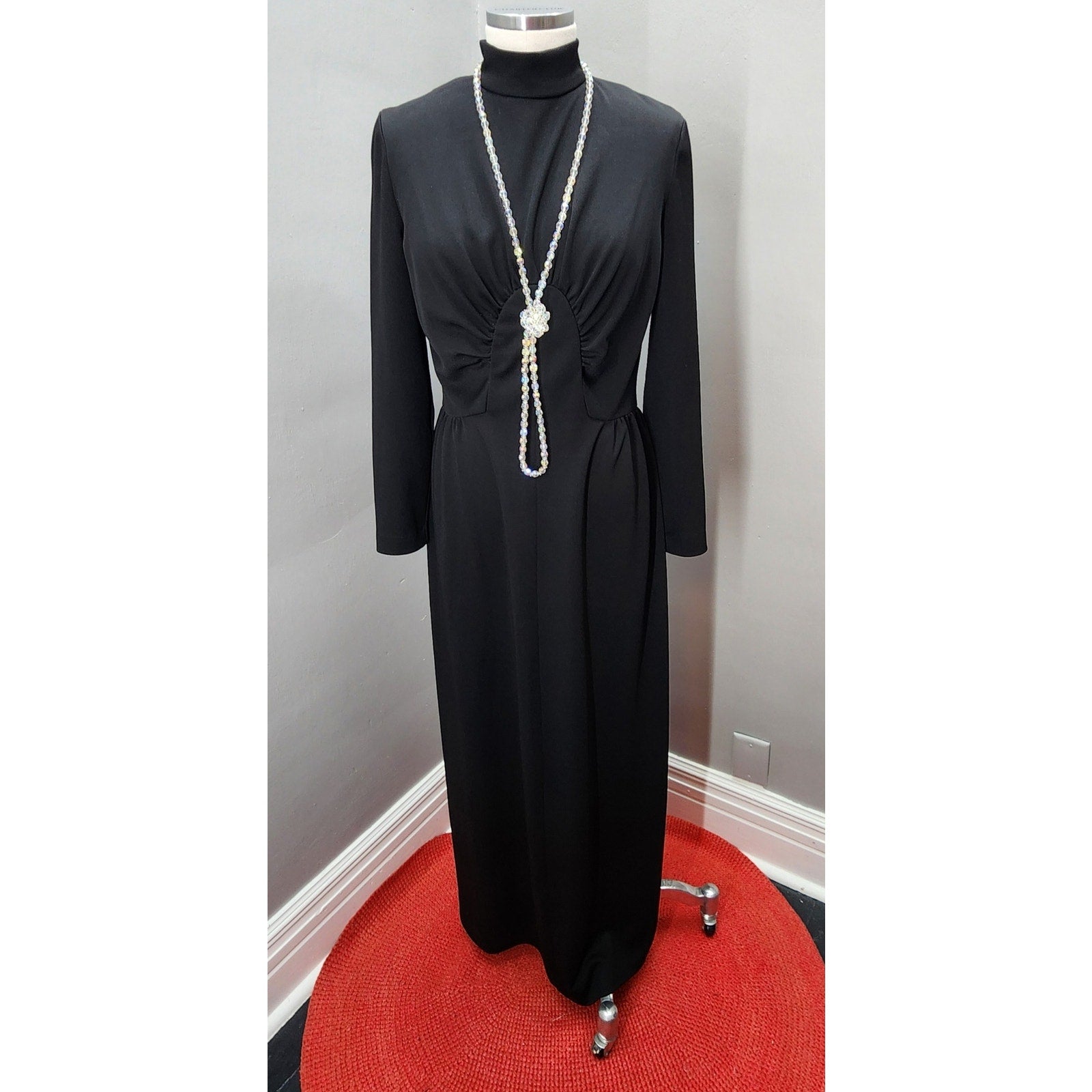 1970s Black Maxi Dress with Sunburst Bodice, nipped waist, long sleeves and mock turtleneck.